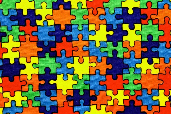 Pozadí z látky s kousky puzzle — Stock fotografie