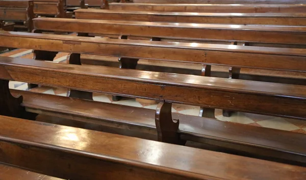 Wooden benches inside a church — Stock Photo, Image
