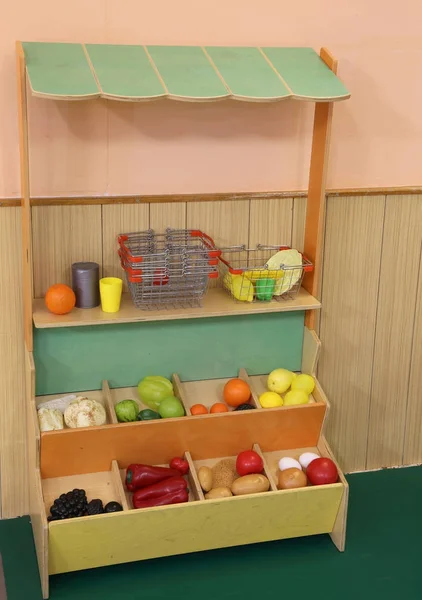 Рынок пластиковых фруктов будет играть в детском саду, где играют дети — стоковое фото