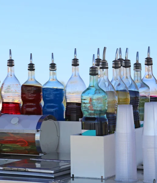 bottles of juices and syrups at the seaside bar