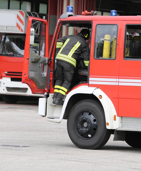 Pompiers courageux et leur camion de pompiers — Photo