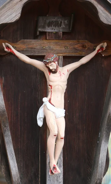 Wooden statue of crucified Jesuit and the INRI writings above th — Stock Photo, Image