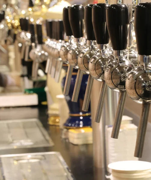 Taps to spill beer in the London pub — Stock Photo, Image