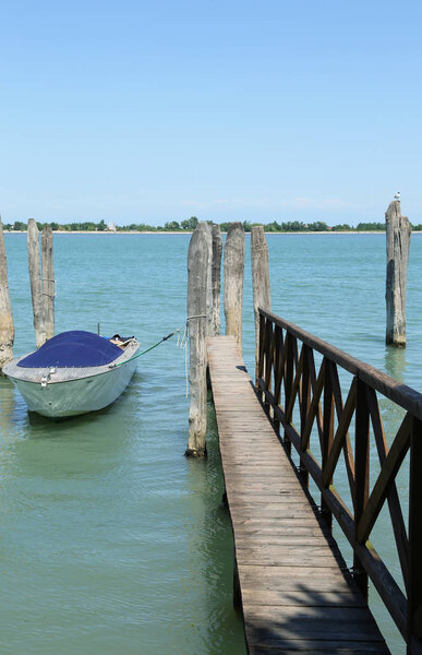 wooden walkway to reach the boats moored on the pier