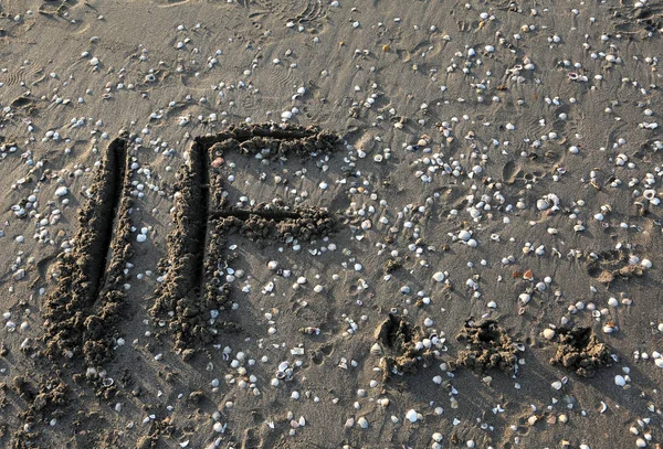 Big IF inscription on the sea sand with the three suspension poi — Stock Photo, Image