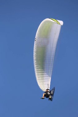 yeti hang glider yüksek bir kişi sit ile mavi gökyüzünde uçar.