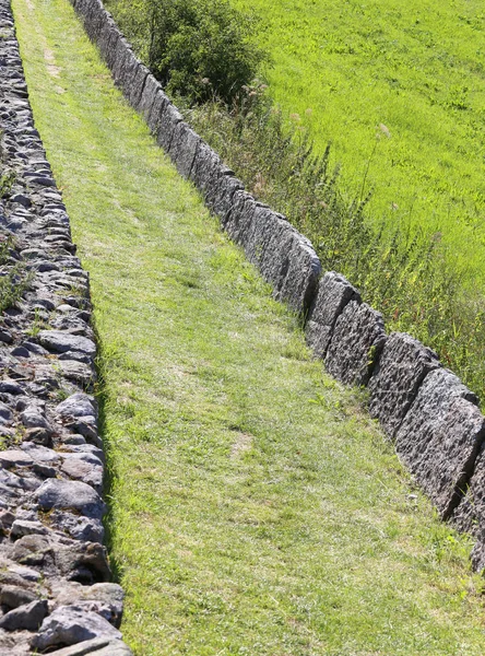 Bergsstig kantad av sten block — Stockfoto