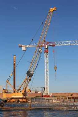 Vinç bir avlunun bir baraj inşaatı sırasında sahil üzerinde