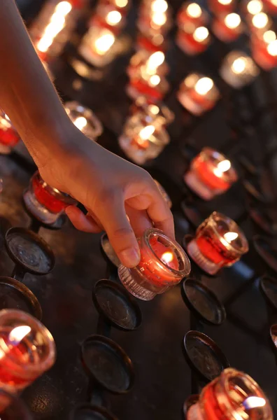 Hand of little girl takes a candle Stock Image