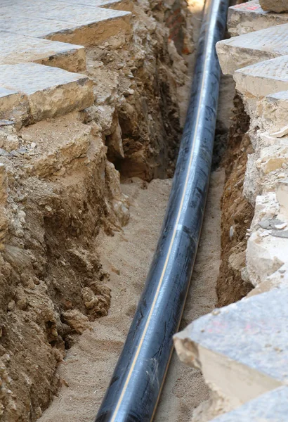 Big black pipe on the trench — Stock Photo, Image