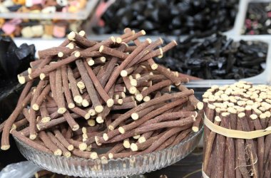 chopsticks of pure licorice root for sale at the market speciali clipart
