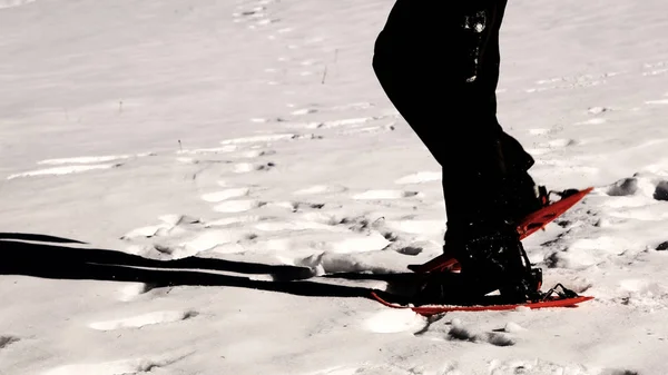 Man snowshoeing with orange snowshoes  in winter with special ef — Stock Photo, Image