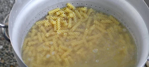 Pasta called FUSILLI in Italy cooked in the water — Stock Photo, Image