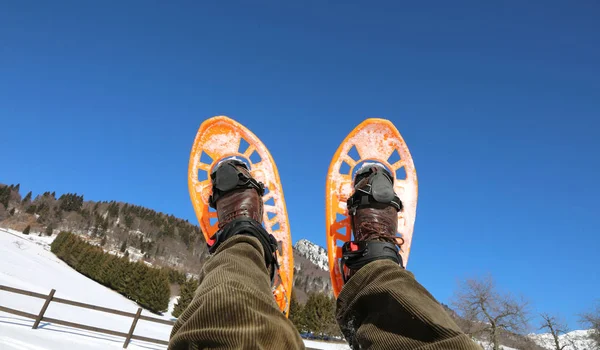 Two orange snowshoes in winter and blue sky on background — Stock Photo, Image