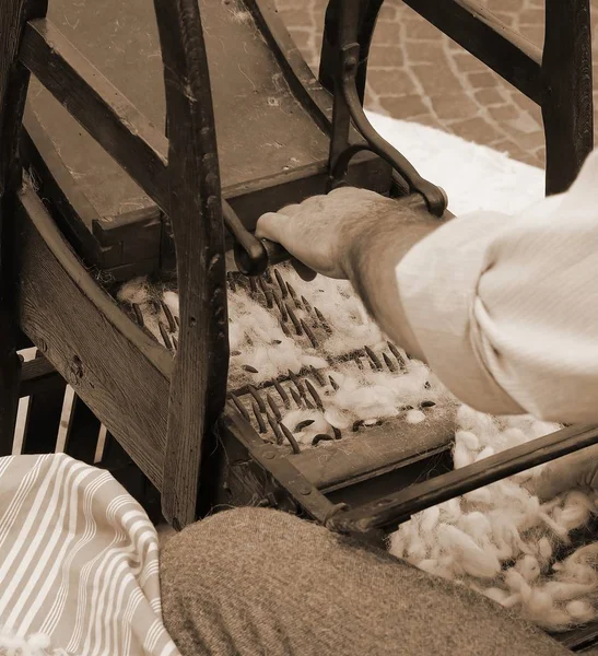 Elder carder while carding wool with sepia toned — Stock Photo, Image