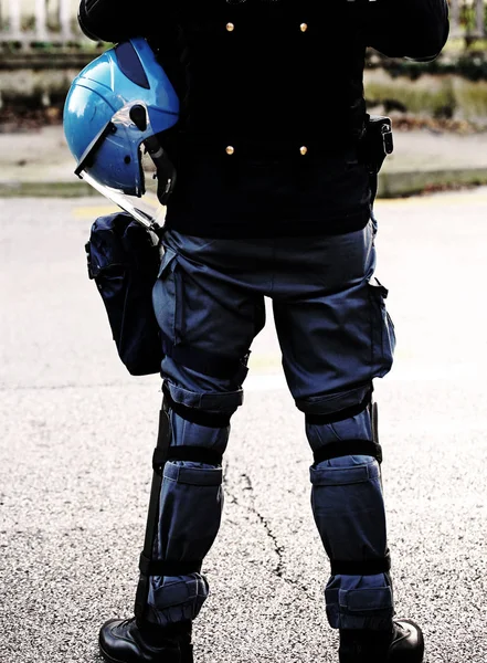 Polizist mit Helm und Schlagstock mit dunkler Wirkung — Stockfoto