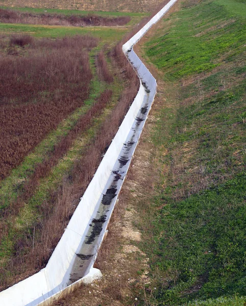 Weißer Betongraben auf dem Feld, um Wasser zur Bewässerung zu transportieren — Stockfoto