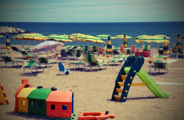 playground on the sea beach in summer with vintage effect clipart