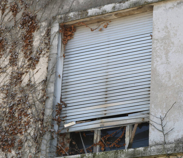 Old windows of an abandoned house without person