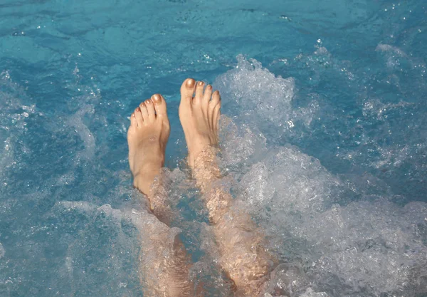 Feet during the hydromassage session in the spa pool — Stock Photo, Image