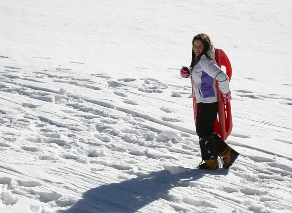 Little girl brings the sled by hand — Stock Photo, Image