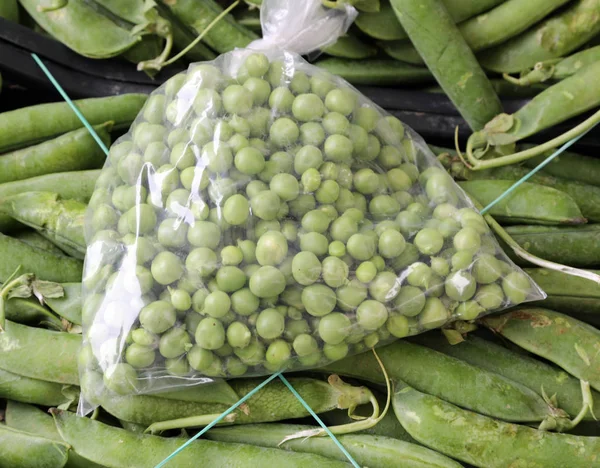 Full bag of big green peas — 스톡 사진