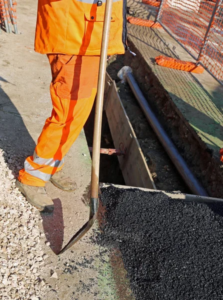 Man with high visibility clothing while working for laying techn — Stock Photo, Image