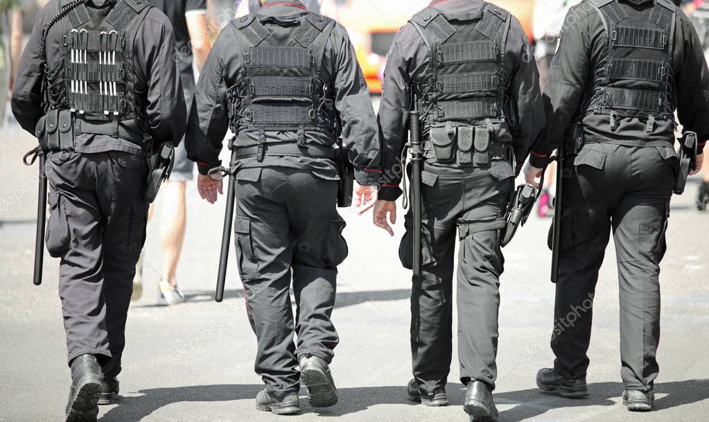 Four policemen with antiriot uniform