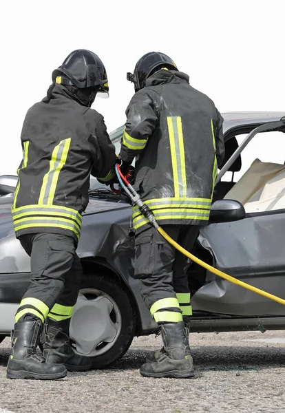 Firefighters use a shear to open the car door — Stock Photo, Image