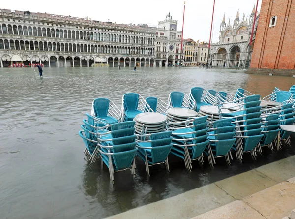 Chairs and tables submerged by high water during the high tide i
