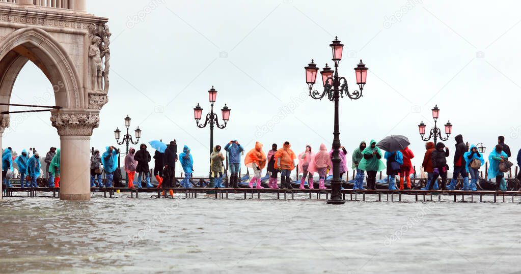 many people on the walkway near Ducal Palace in Venice in Italy