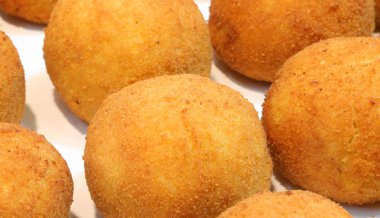 many big balls of rice called Arancini in Italian Language clipart