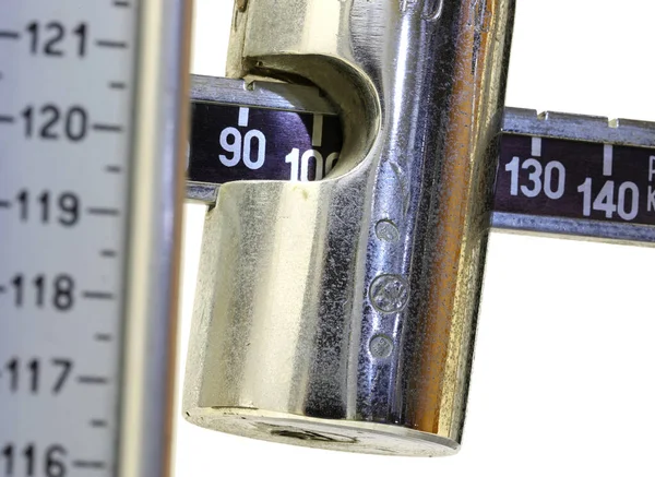 Detail of the steel weight of an ancient scale for weighing and — Stock Photo, Image