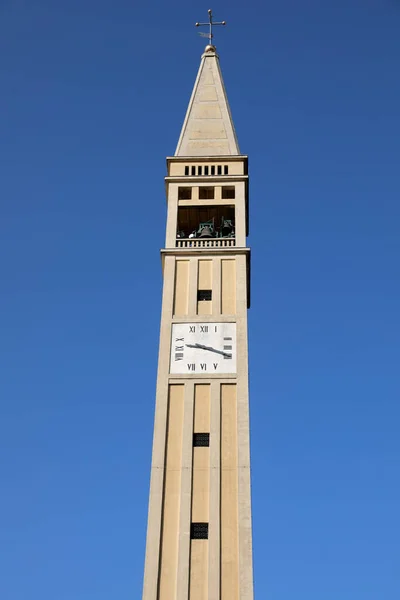 Sehr hoher Glockenturm mit pyramidenförmiger Turmspitze mit quadratischem Sockel und — Stockfoto