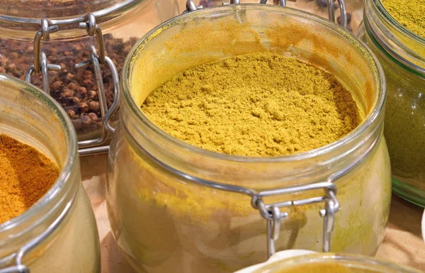 Jar with yellow curry powder — Stok fotoğraf