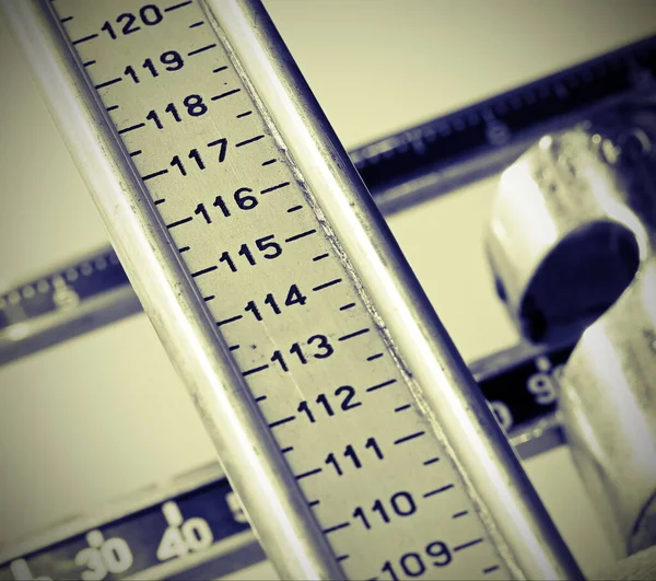 학생의 키를 측정하기 위해 긴 졸업 한 막대기를 사용하는 것입니다. — 스톡 사진