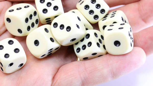 Many white dice on the hand — 스톡 사진