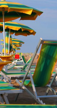 many sun umbrellas and deskchairs