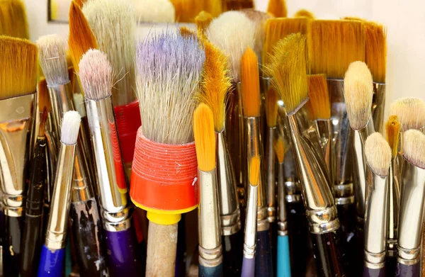 Brushes with bristles turned upwards in a painting studio — Stock Photo, Image
