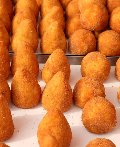 fried stuffed balls of rice called ARANCINO in Italian Language for sale at the street food stall in southern Italy