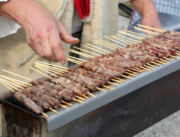 Chef cooking of mutton kebabs called ARROSTICINI in italian language