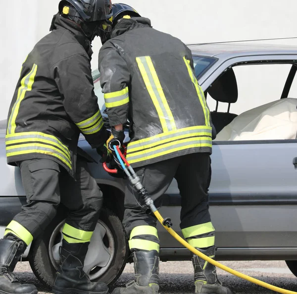 Strażacy Podczas Cięcia Arkusza Uszkodzonego Samochodu Specjalnymi Nożycami Wypadku Drogowym — Zdjęcie stockowe