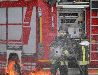 brave firefighter with helmet during the extinguishing of a fire while practicing in the fire station