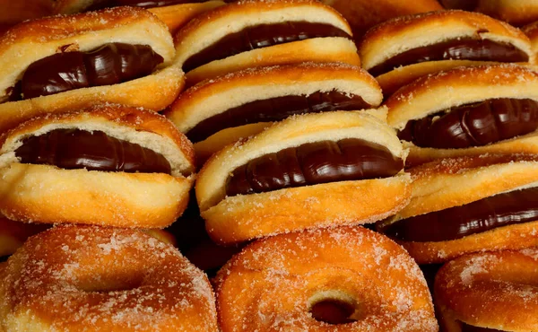 many donuts stuffed with chocolate cream for sale in the artisan pastry shop