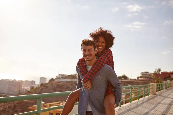 Loving young couple piggyback — Stock Photo, Image