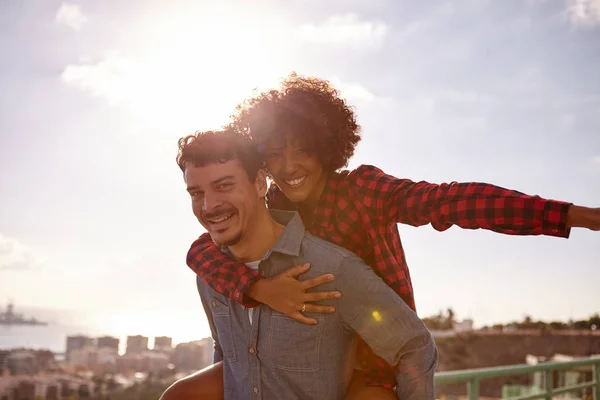 Loving young couple piggyback — Stock Photo, Image