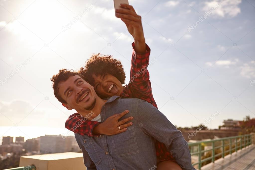 happy young couple taking selfie