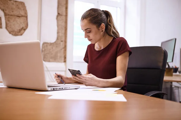 Ung affärskvinna sitter vid skrivbord — Stockfoto