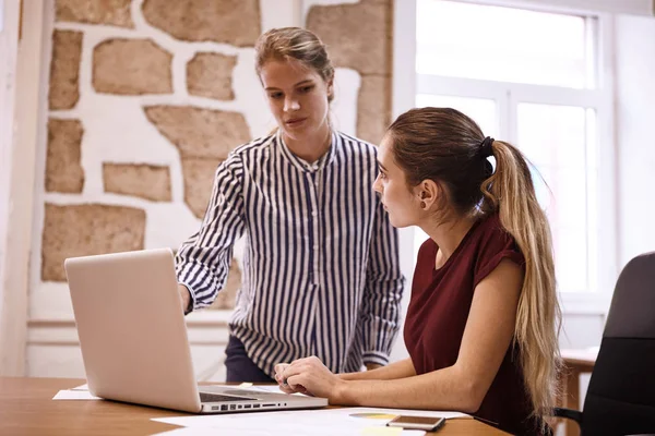 Unga affärskvinnor tittar på laptop — Stockfoto