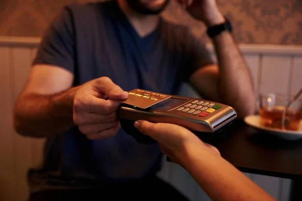 Young man giving credit card